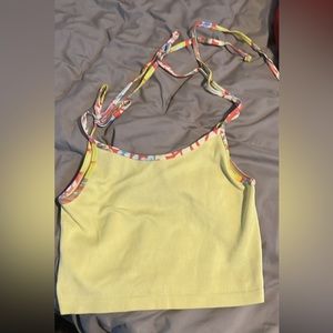 A yellow crop top with tie able straps